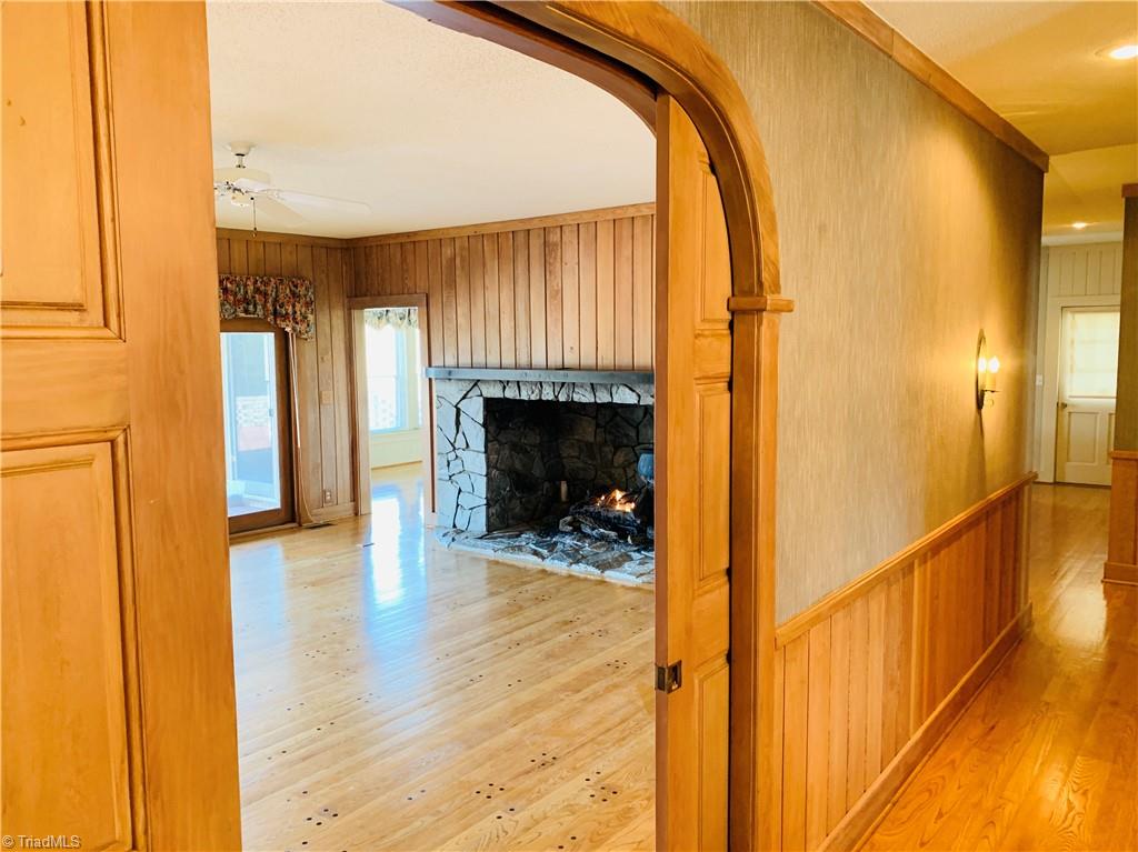 1198 Big Oak Road Germanton, NC 27019 - Photo 9 of 50 Pegged hardwoods, amazing rock gas log fireplace, and view for days make this living area exceptional.