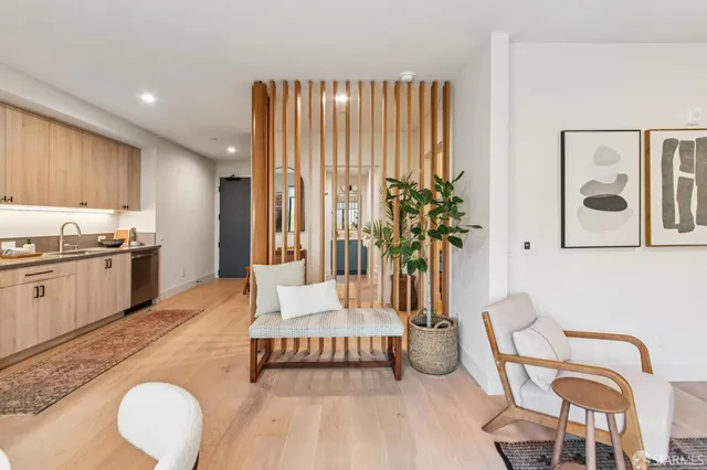 a living room with furniture and a kitchen area