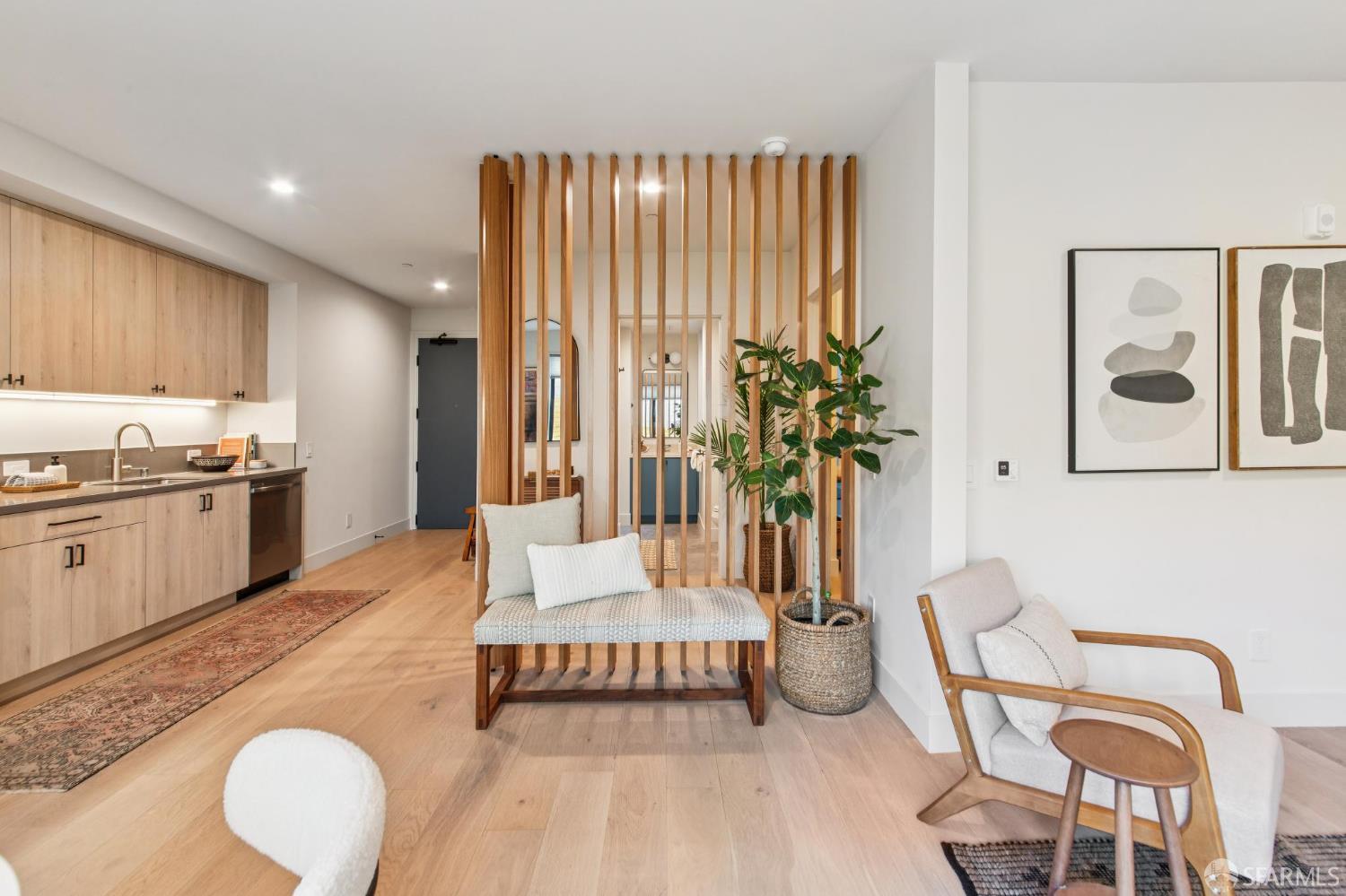 986 South Van Ness Avenue, Unit 203 San Francisco, CA 94110 - Photo 11 of 34 a living room with furniture and a kitchen area