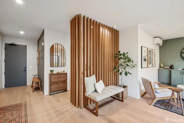 a living room with furniture and a potted plant