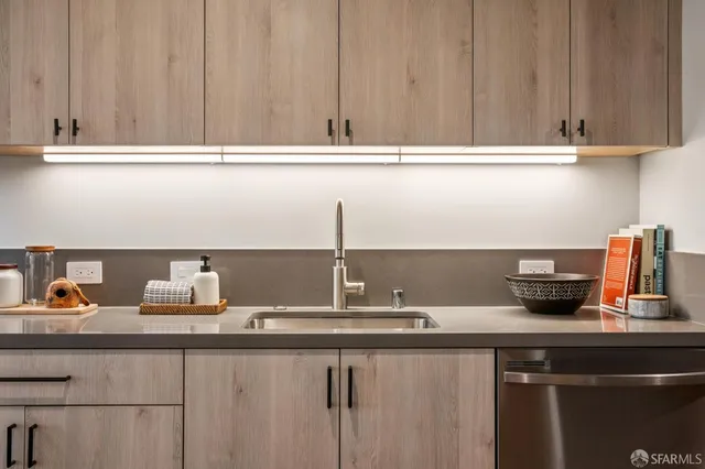 a kitchen with a sink and cabinets