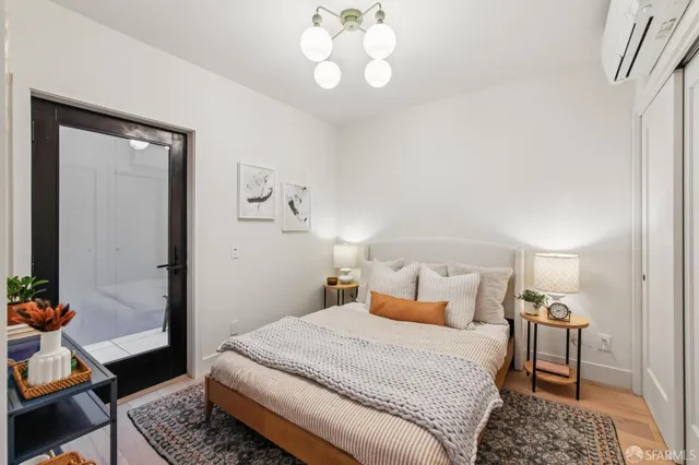 a bedroom with a bed and a chandelier