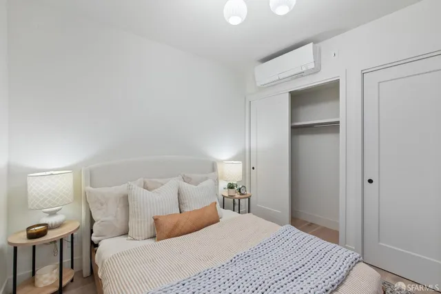 a bedroom with a bed and a lamp