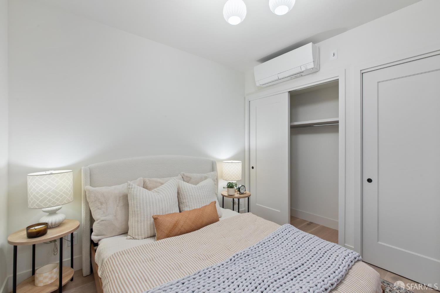 986 South Van Ness Avenue, Unit 203 San Francisco, CA 94110 - Photo 22 of 34 a bedroom with a bed and a lamp