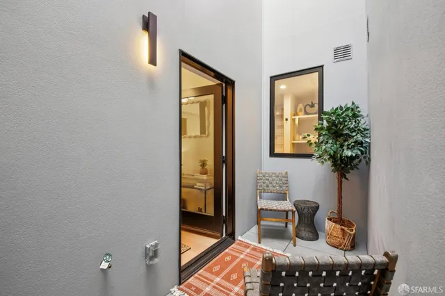 a living room with furniture and a potted plant