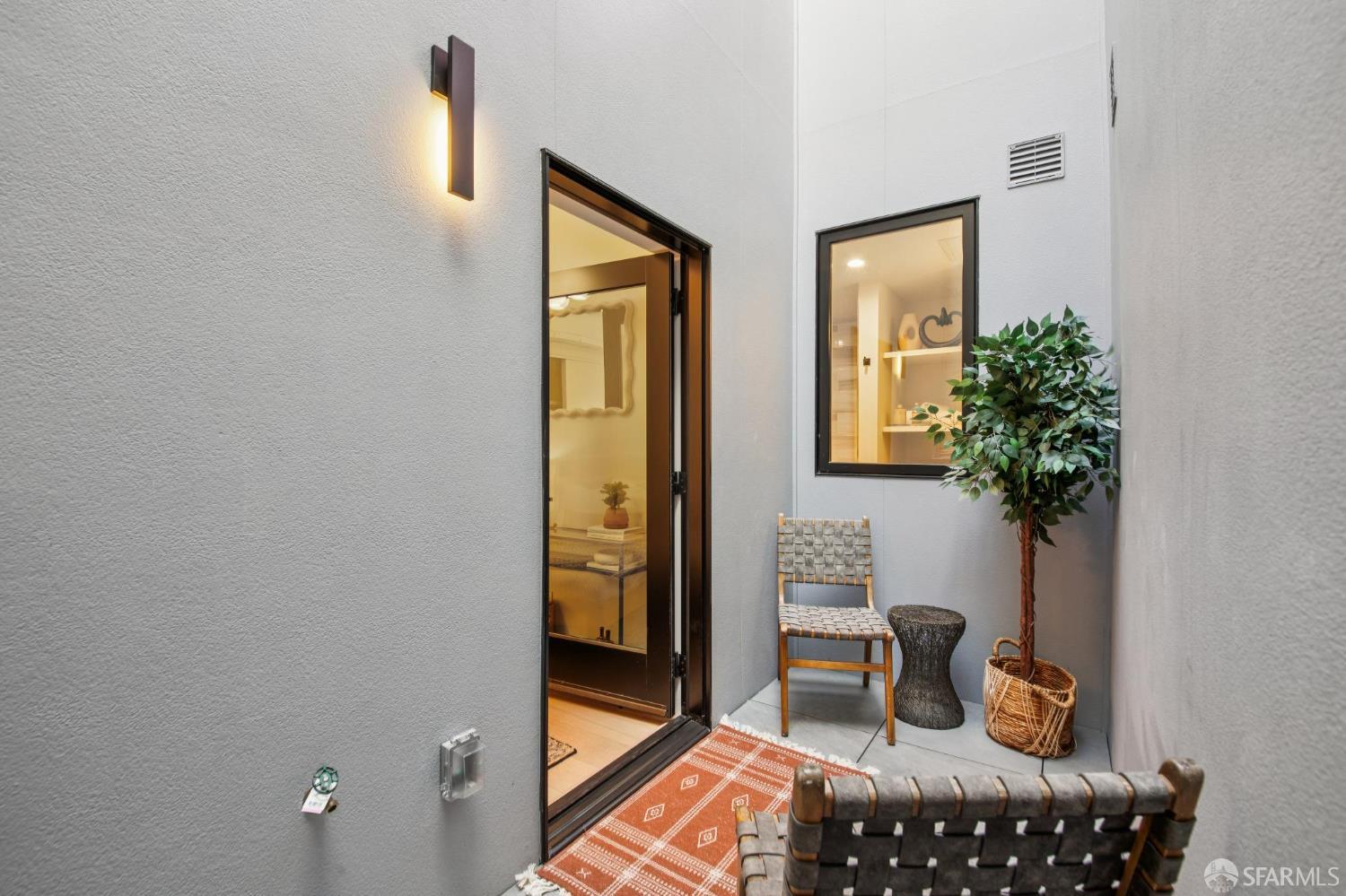 986 South Van Ness Avenue, Unit 203 San Francisco, CA 94110 - Photo 26 of 34 a living room with furniture and a potted plant