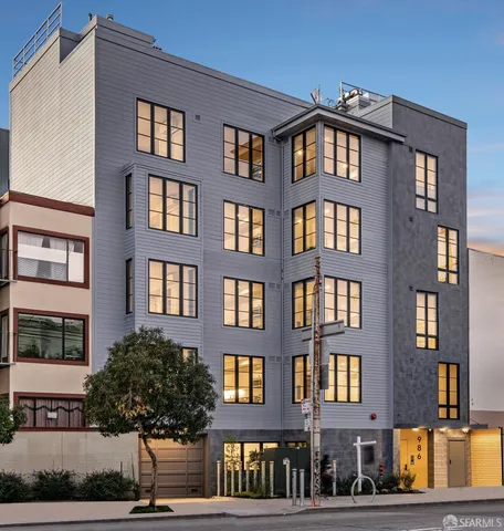 a front view of a residential apartment building with a yard