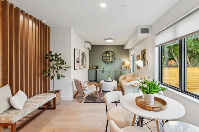 a living room with furniture and a potted plant