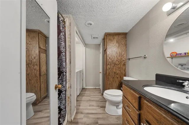 a bathroom with a sink a toilet a mirror and shower