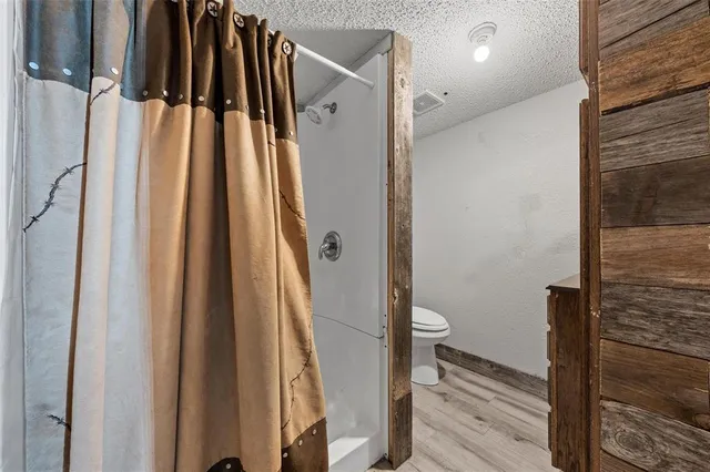 a bathroom with a shower toilet and sink