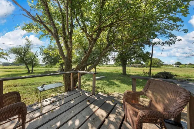 a view of a table and chairs in the garden