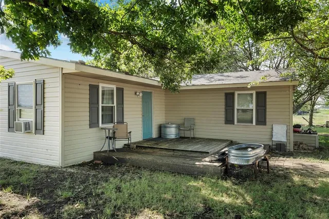 a backyard of a house with outdoor seating