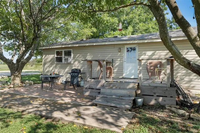 a view of backyard with outdoor seating and trees