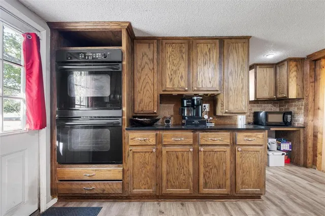 a kitchen with granite countertop a stove and a refrigerator
