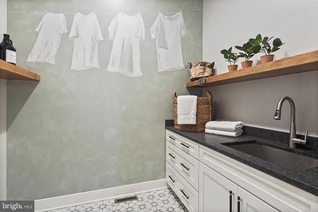 a kitchen with granite countertop appliances cabinets and wooden floor