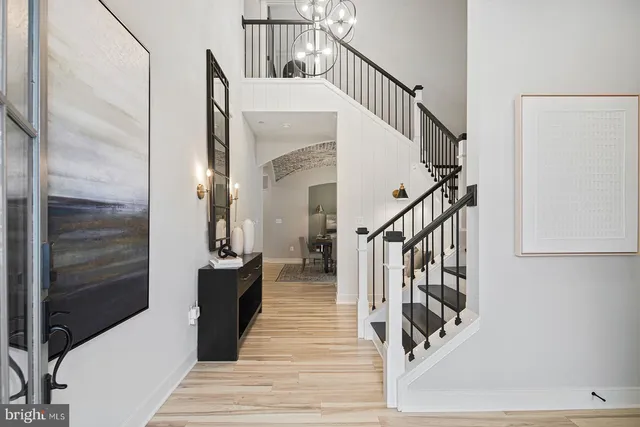 a view of front door and bedroom with wooden floor