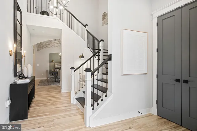 a view of entryway and hall with wooden floor