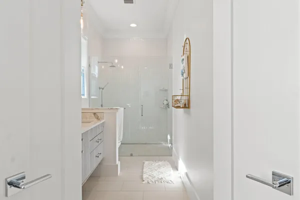 view of a bathroom with a shower and a sink