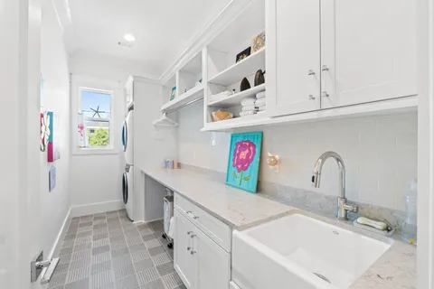 a utility room with sink dryer and washer