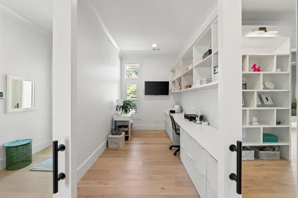a hallway with a dining table chairs and couches