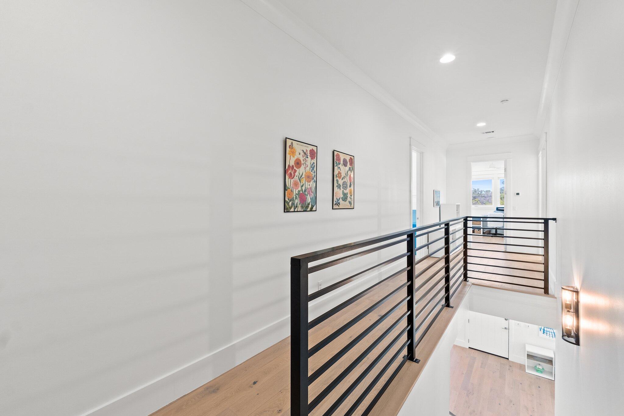 479 Ridge Road Santa Rosa Beach, FL 32459 - Photo 29 of 45 a view of a hallway with wooden floor and stairs