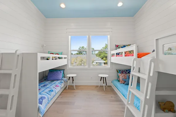 a bedroom with baby toys and a window