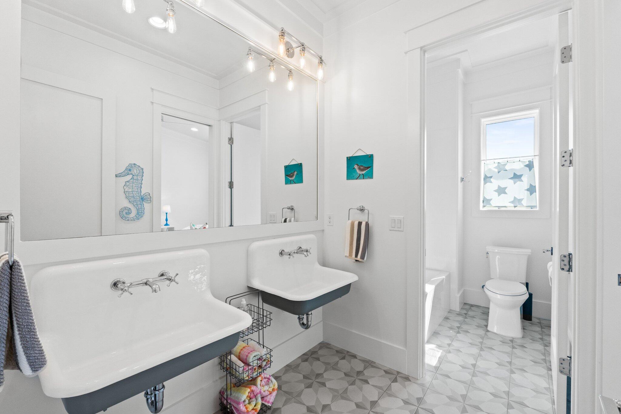 479 Ridge Road Santa Rosa Beach, FL 32459 - Photo 35 of 45 a spacious bathroom with a sink a toilet and a mirror