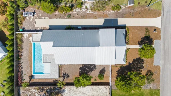 an aerial view of a house with a yard