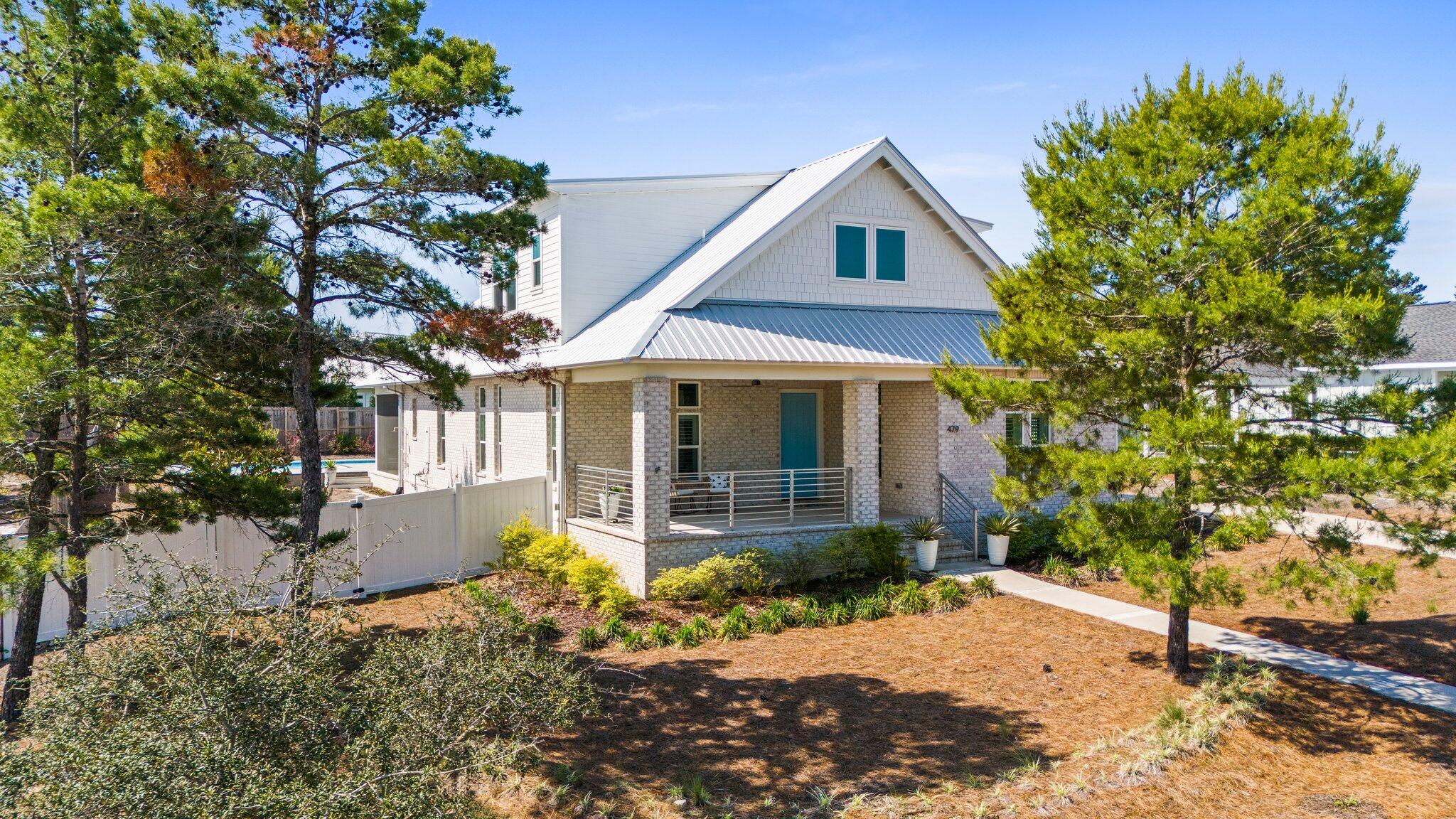 479 Ridge Road Santa Rosa Beach, FL 32459 - Photo 45 of 45 a front view of a house with a yard and potted plants