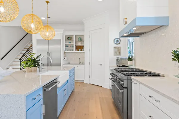 a kitchen with stainless steel appliances a stove a sink and a refrigerator