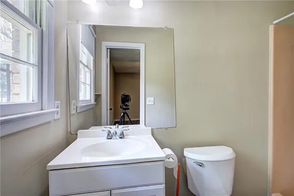 a bathroom with a shower and toilet