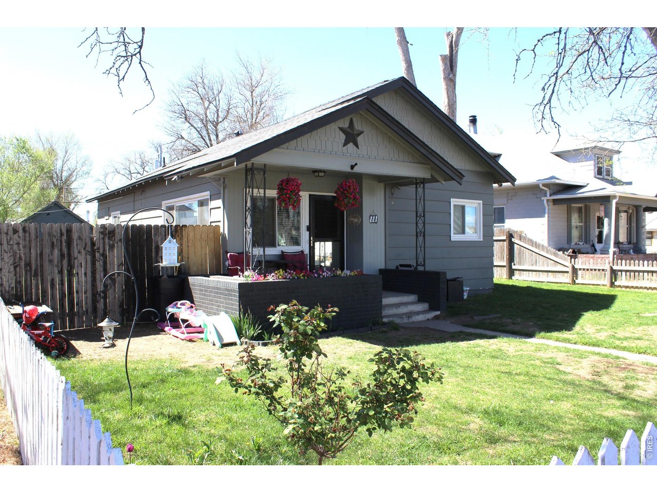811 Prospect Street Fort Morgan, CO 80701 - Photo 1 of 19 a front view of a house with garden