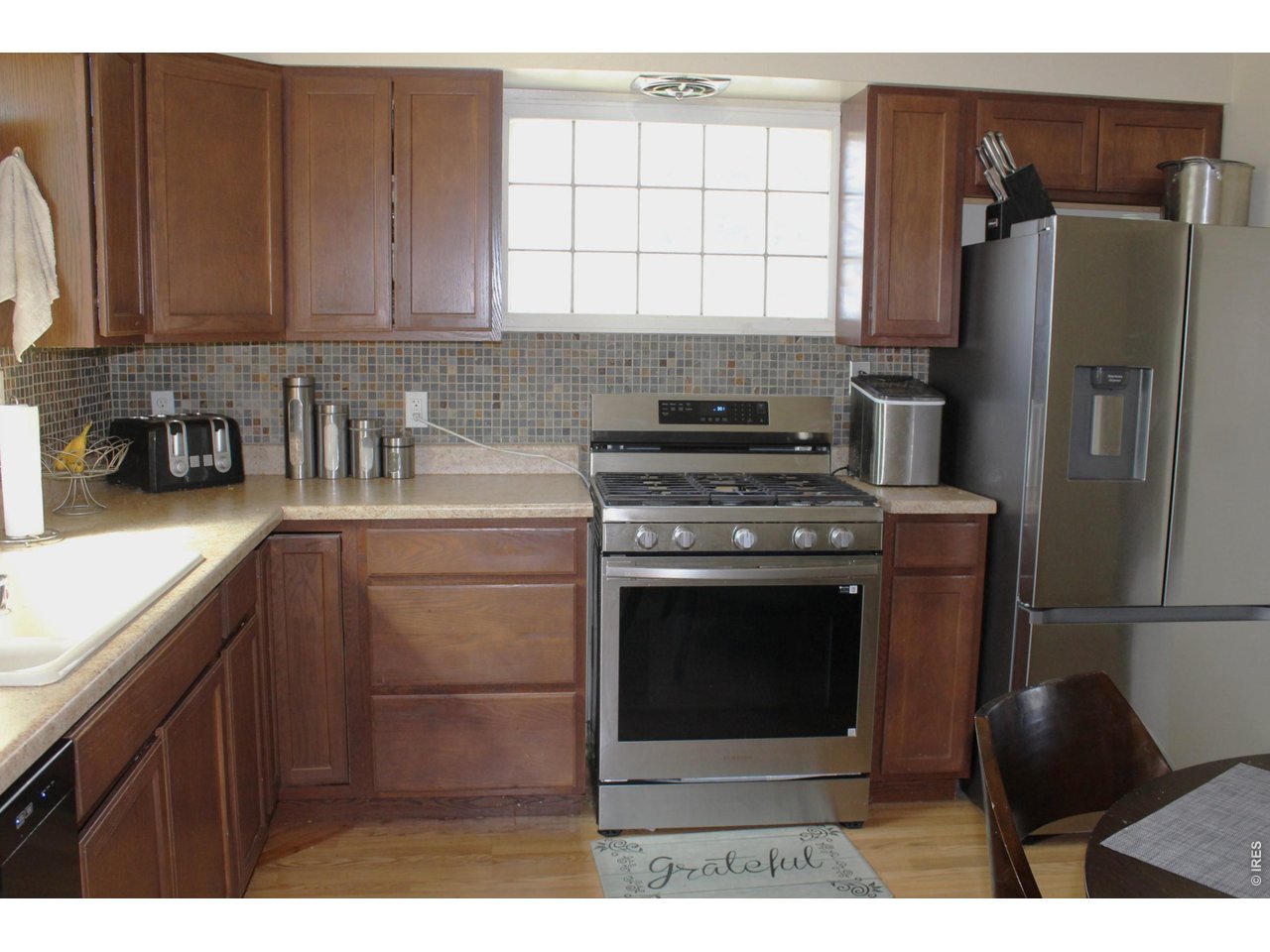 811 Prospect Street Fort Morgan, CO 80701 - Photo 11 of 19 a kitchen with stainless steel appliances granite countertop a stove a refrigerator and a sink