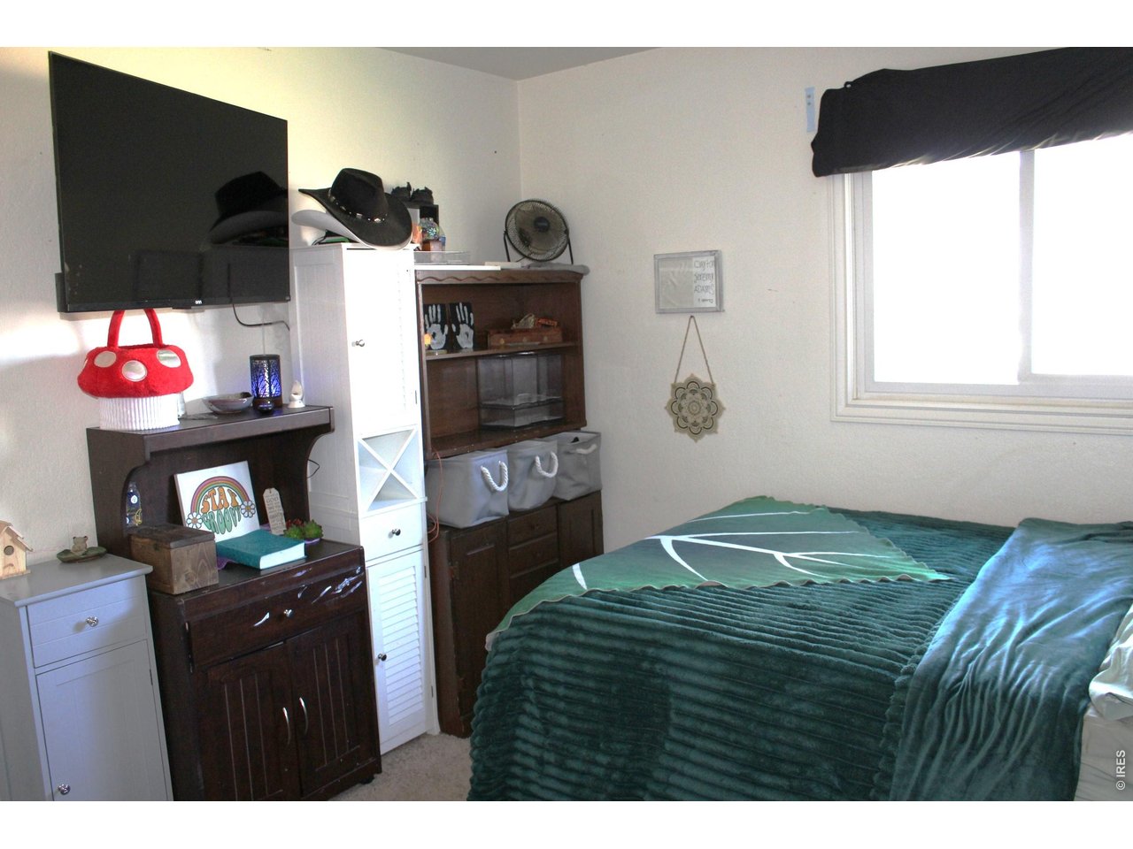 811 Prospect Street Fort Morgan, CO 80701 - Photo 6 of 19 a bedroom with a bed and a flat tv screen