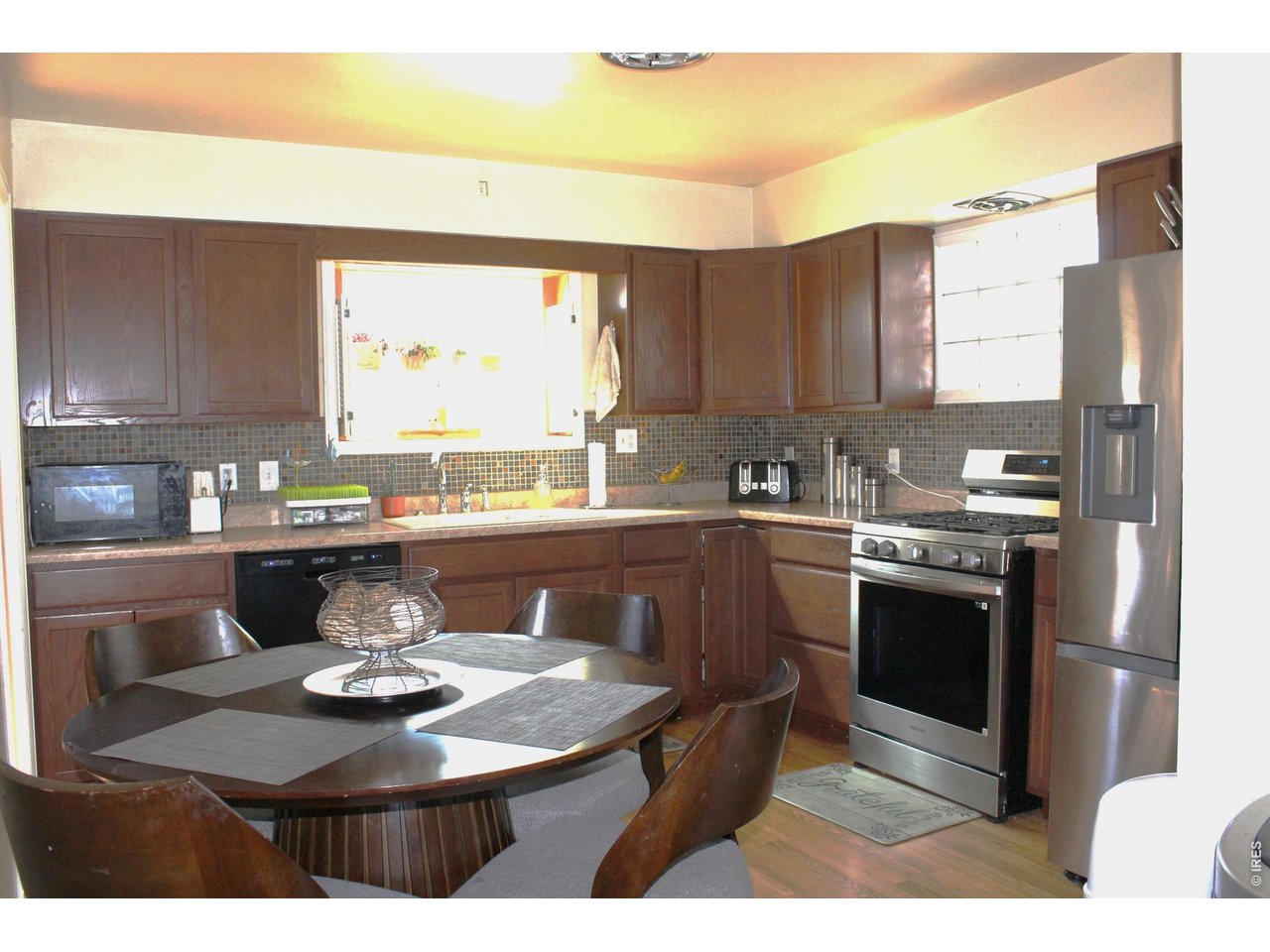811 Prospect Street Fort Morgan, CO 80701 - Photo 10 of 19 a kitchen with a stove a sink and a refrigerator