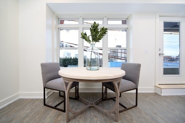 20 Penniman Road, Unit 101 Boston, MA 02134 - Photo 7 of 8 a view of a dining room with furniture window and wooden floor