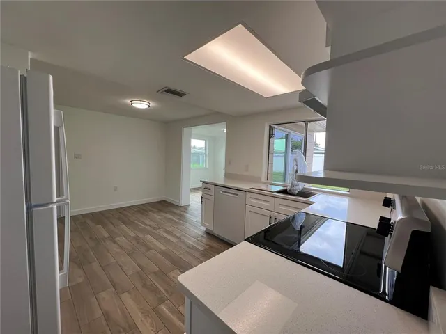 a room with gym equipment and wooden floor