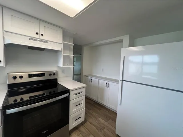 a kitchen with a stove and a refrigerator