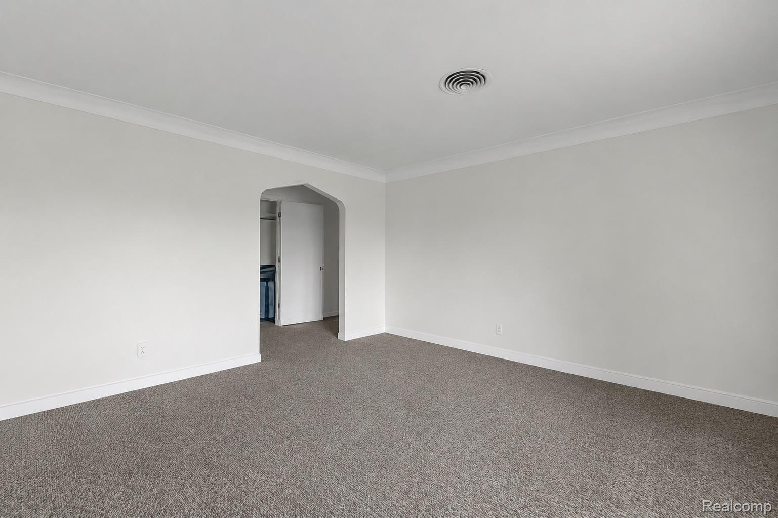 5223 Allen Road Allen Park, MI 48101 - Photo 5 of 12 Spacious room featuring neutral carpeting, white painted walls, and white crown molding