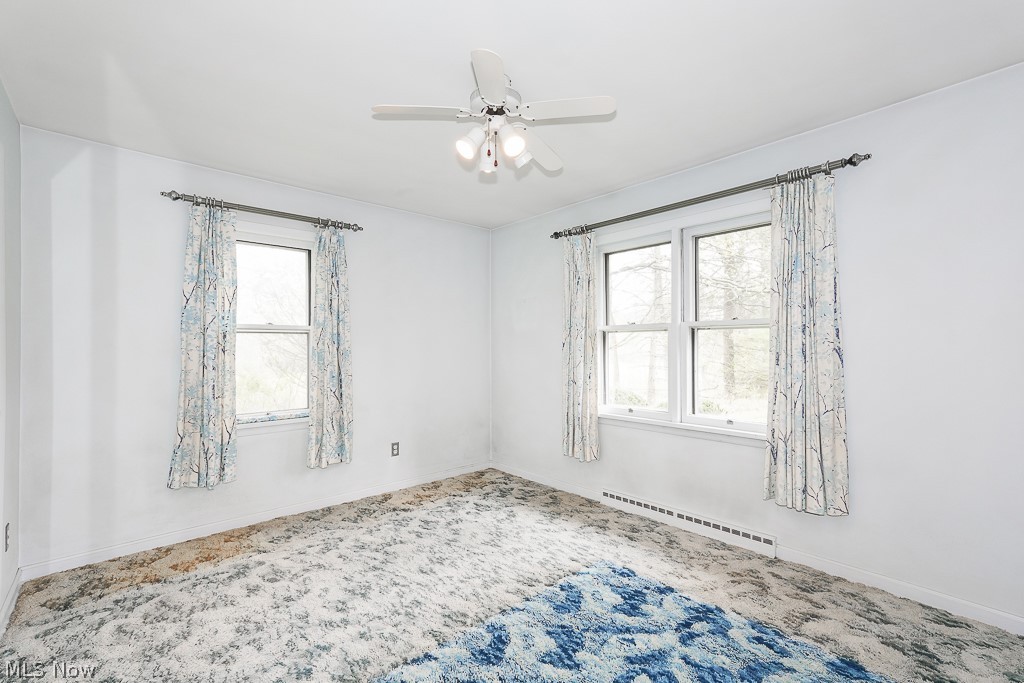 13028 Root Road Columbia Station, OH 44028 - Photo 23 of 35 Spare room featuring a baseboard radiator and ceiling fan