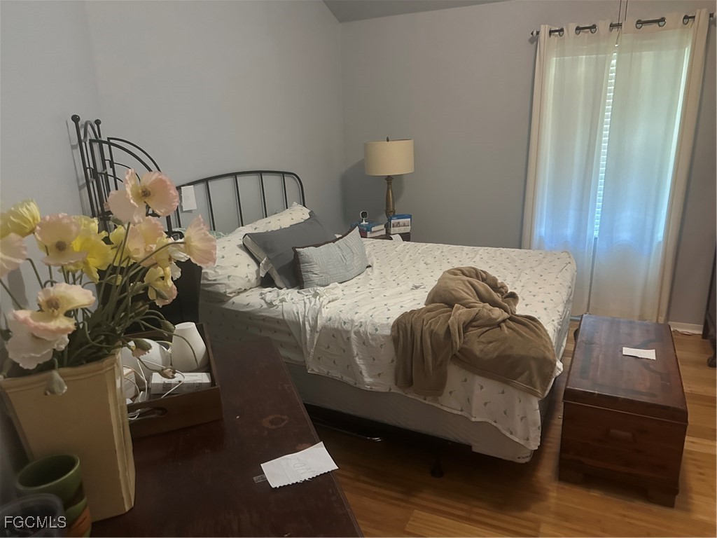 950 Moody Road, Unit 110 North Fort Myers, FL 33903 - Photo 15 of 32 a bedroom with a bed and wooden floor