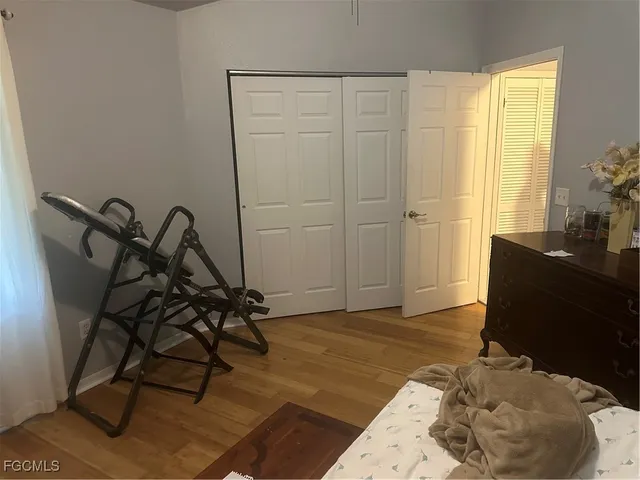 a view of a workspace room with wooden floor and windows