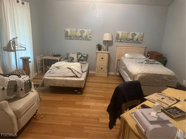 a bedroom with furniture and a wooden floor