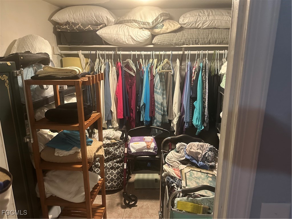 950 Moody Road, Unit 110 North Fort Myers, FL 33903 - Photo 24 of 32 a view of walk in closet with clothes and shoes