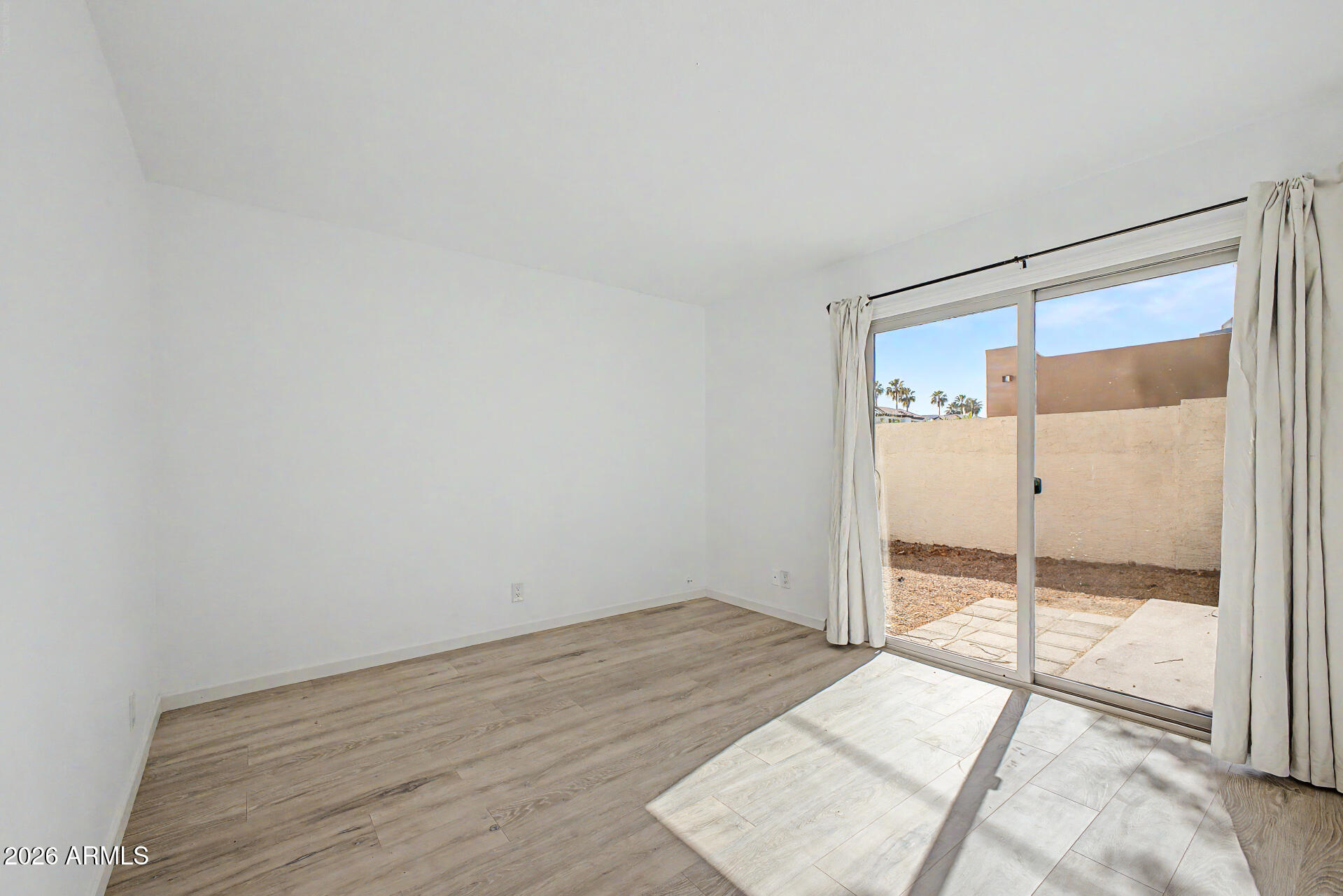 3422 North 12th Place Phoenix, AZ 85014 - Photo 12 of 49 a view of a room with wooden floor and glass door