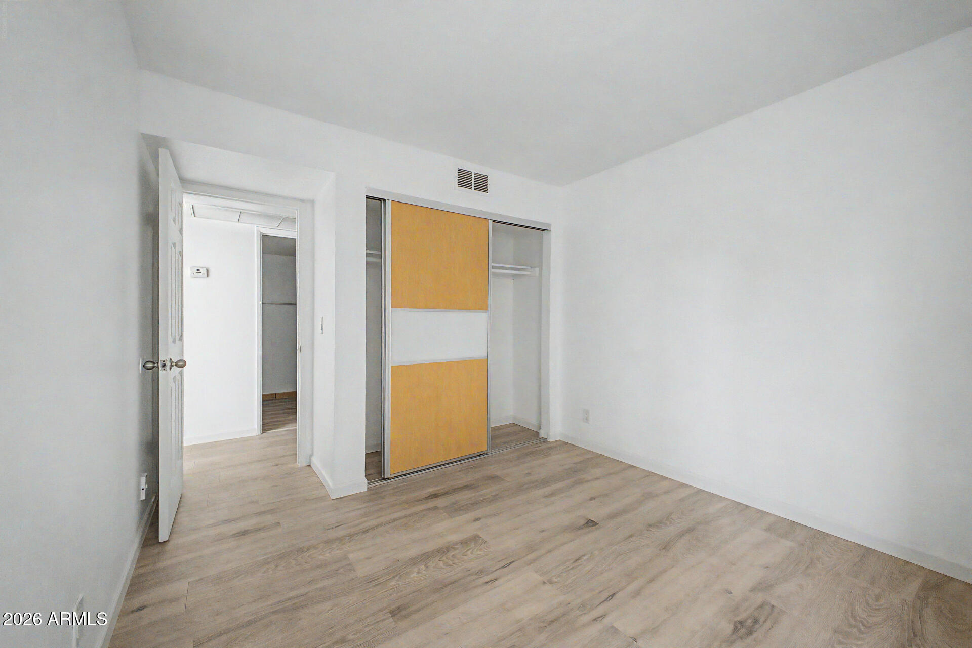 3422 North 12th Place Phoenix, AZ 85014 - Photo 19 of 49 a view of empty room with wooden floor