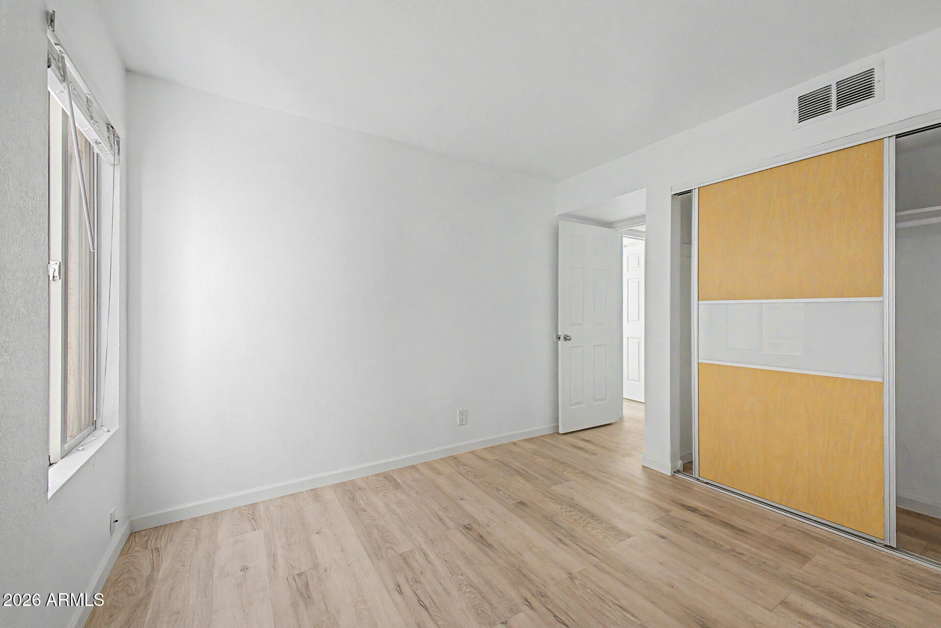 3422 North 12th Place Phoenix, AZ 85014 - Photo 20 of 49 an empty room with wooden floor and windows