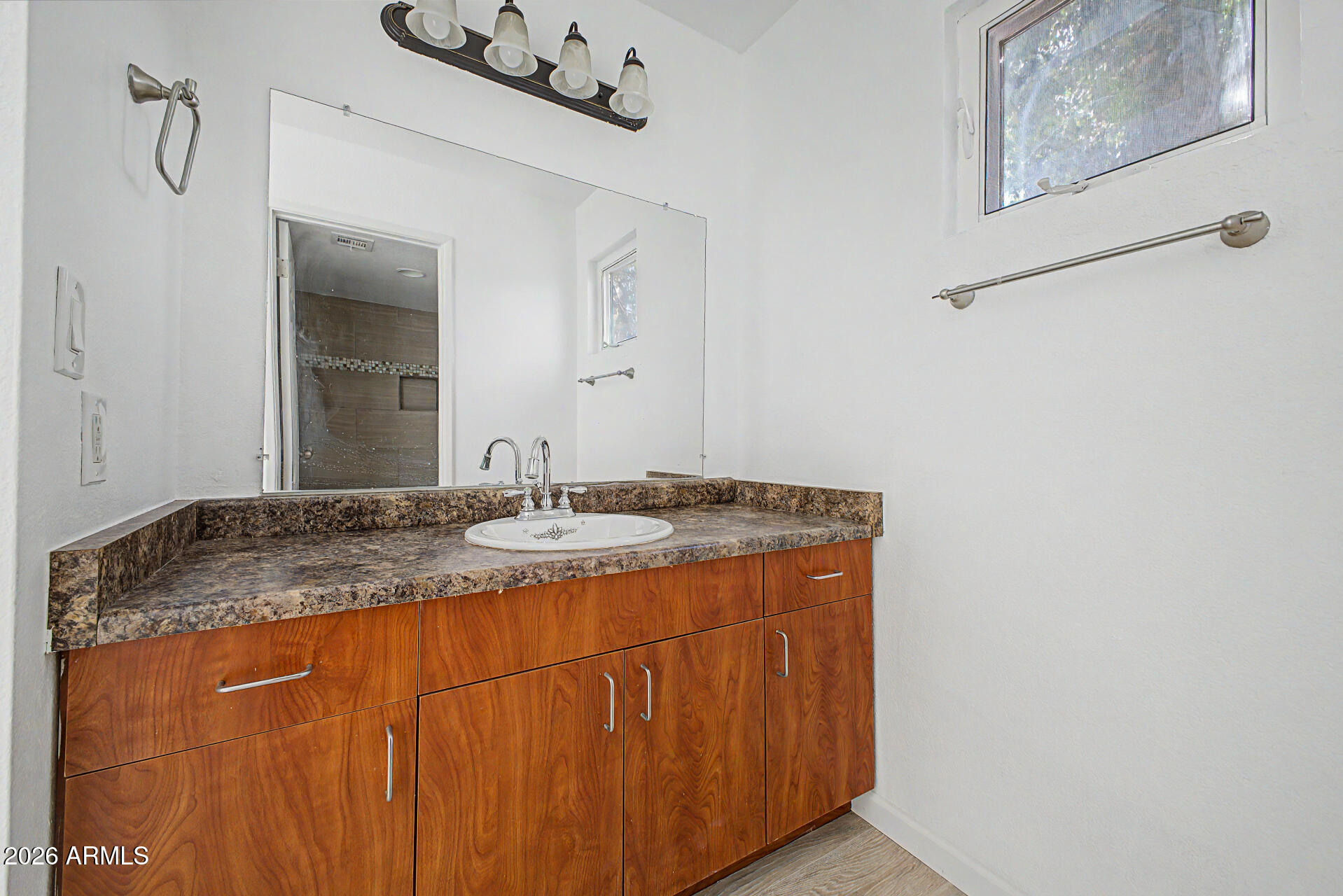 3422 North 12th Place Phoenix, AZ 85014 - Photo 21 of 49 a bathroom with a granite countertop sink and a mirror