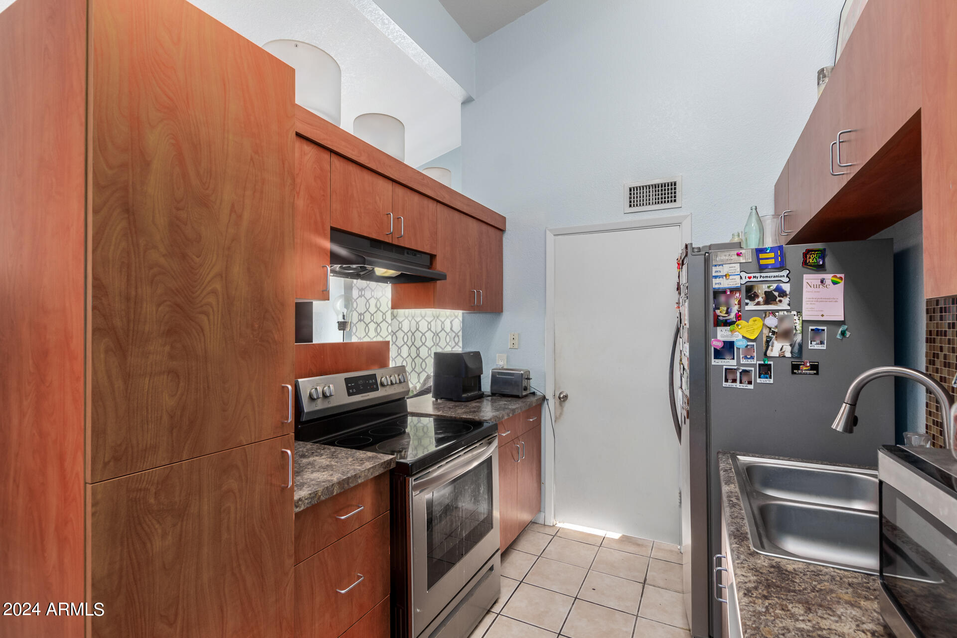 3422 North 12th Place Phoenix, AZ 85014 - Photo 33 of 49 a kitchen with stainless steel appliances granite countertop a refrigerator and a stove