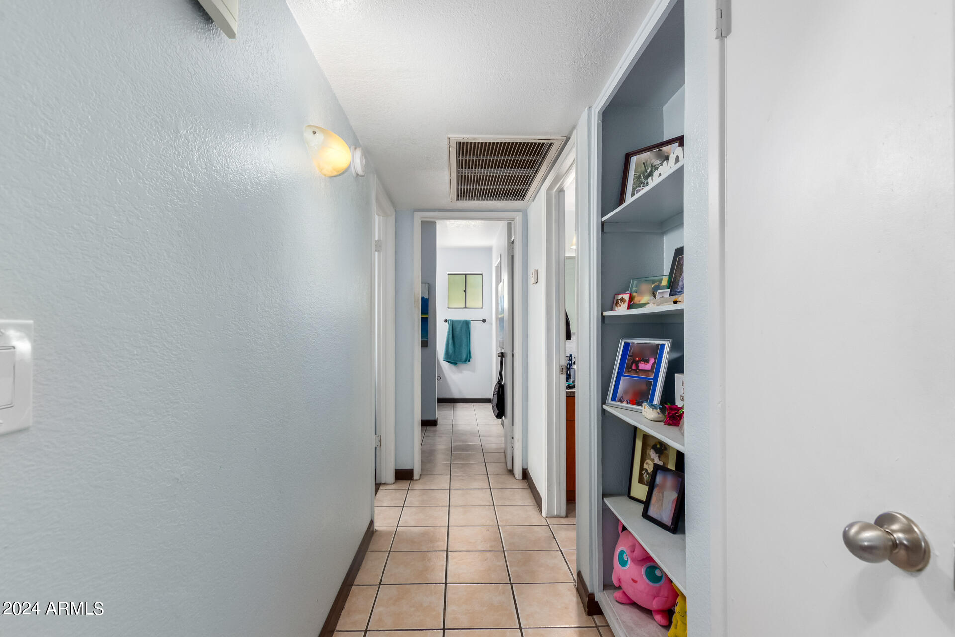 3422 North 12th Place Phoenix, AZ 85014 - Photo 34 of 49 a hallway with cabinets and book shelf